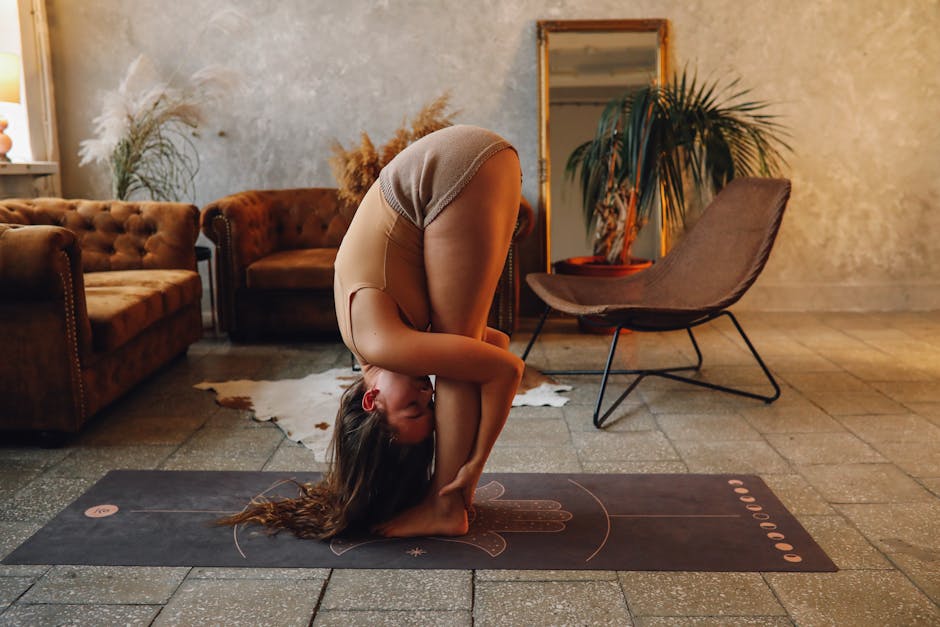 A person comfortably stretching on a yoga mat at home, with a cup of tea nearby